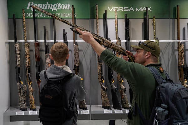 Attendees at the National Rifle Association’s annual meeting last year examining Remington shotguns. Remington’s firearms were used in the Civil War and in both World War I and II.