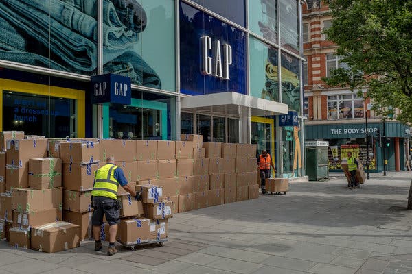 Workers in May stacked boxes from a shoe store closing down on a deserted Oxford Street in London.
